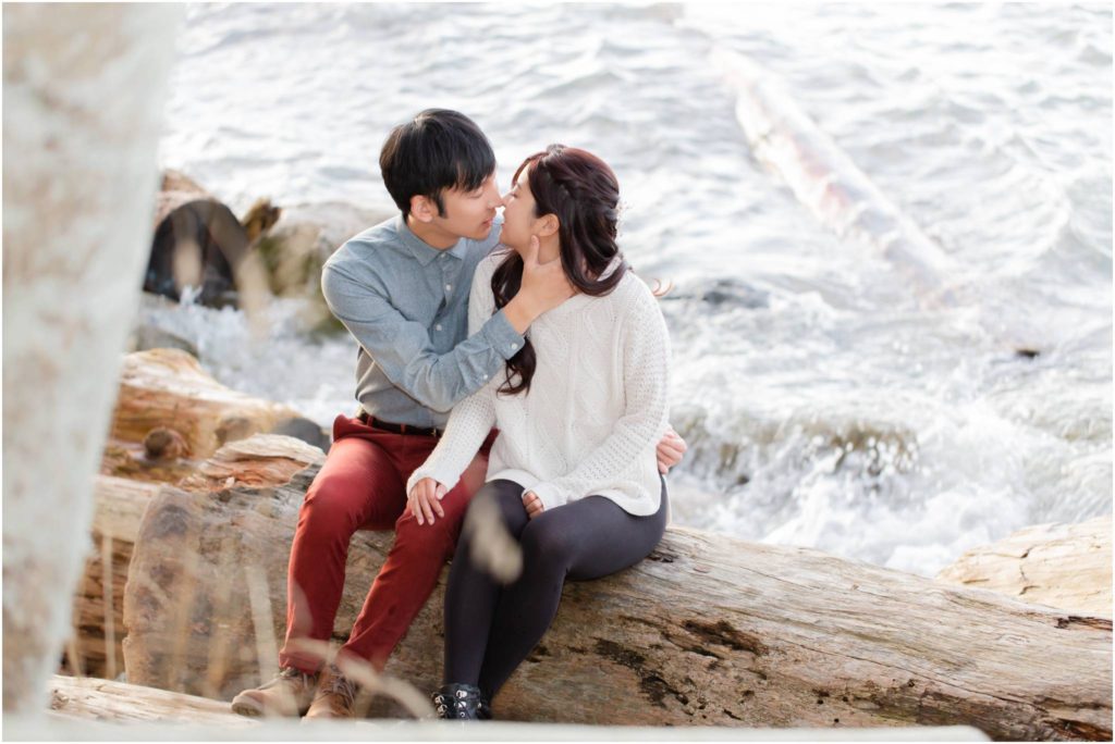 Vancouver Engagement Photo at UBC Acadia Beach, romantic photo of couple sitting on log