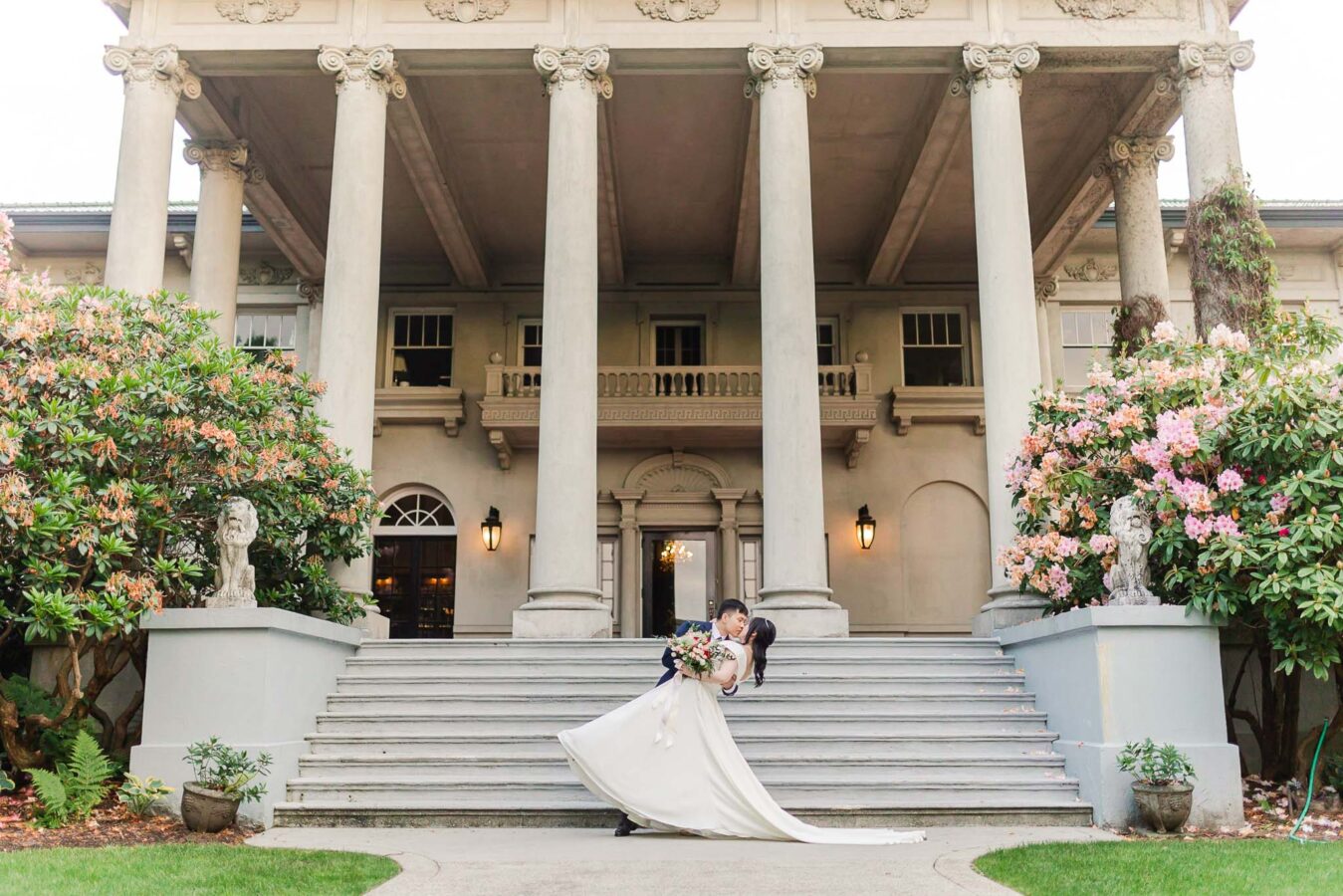 Bride and Groom kissing under the grand staircase of Hycroft Manor, Vancouver wedding photography by Vivian Ng Photography