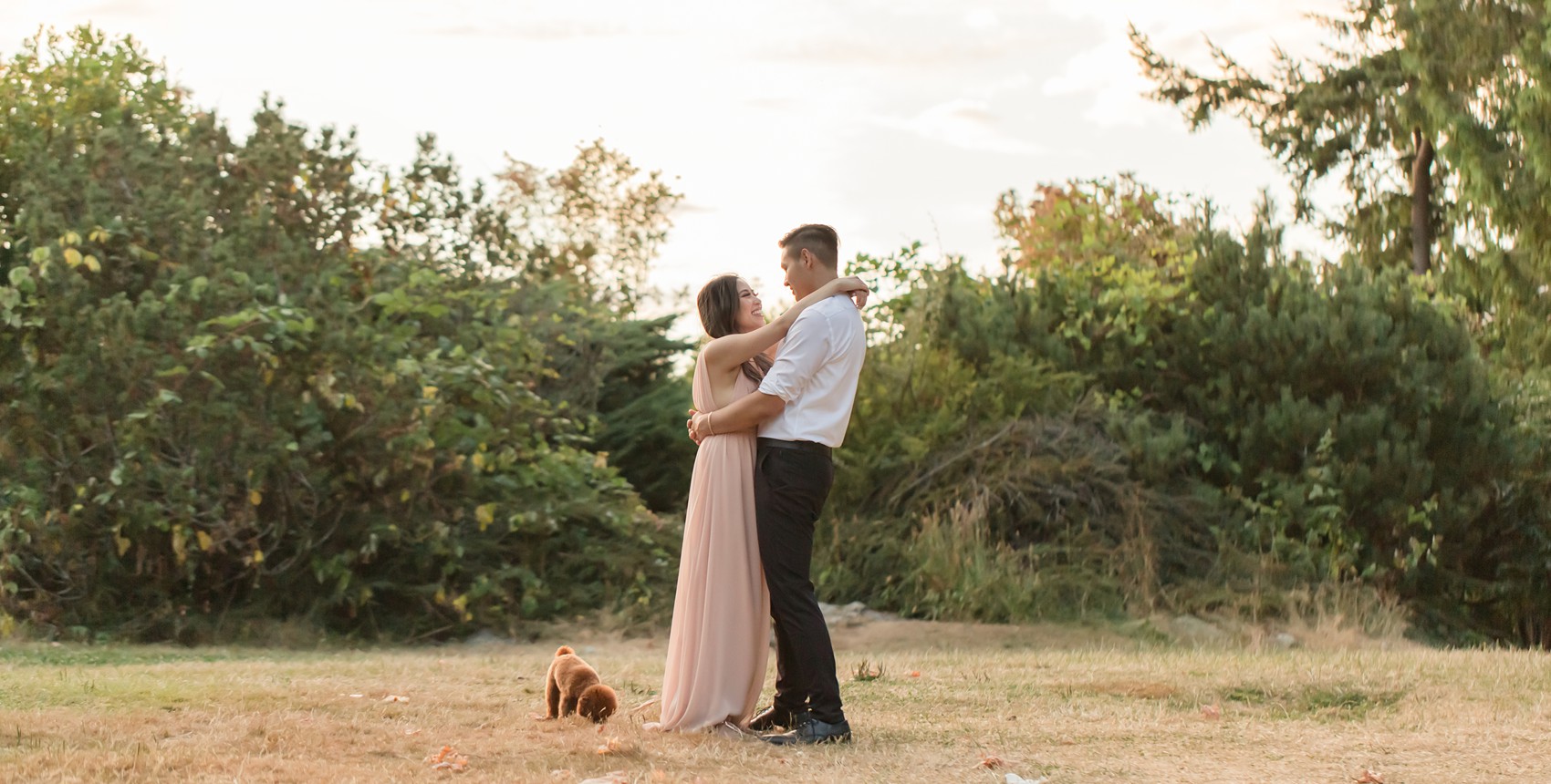 West Vancouver Whytecliff Engagement photos - couple dancing, puppy sniffing the grass next to the couple