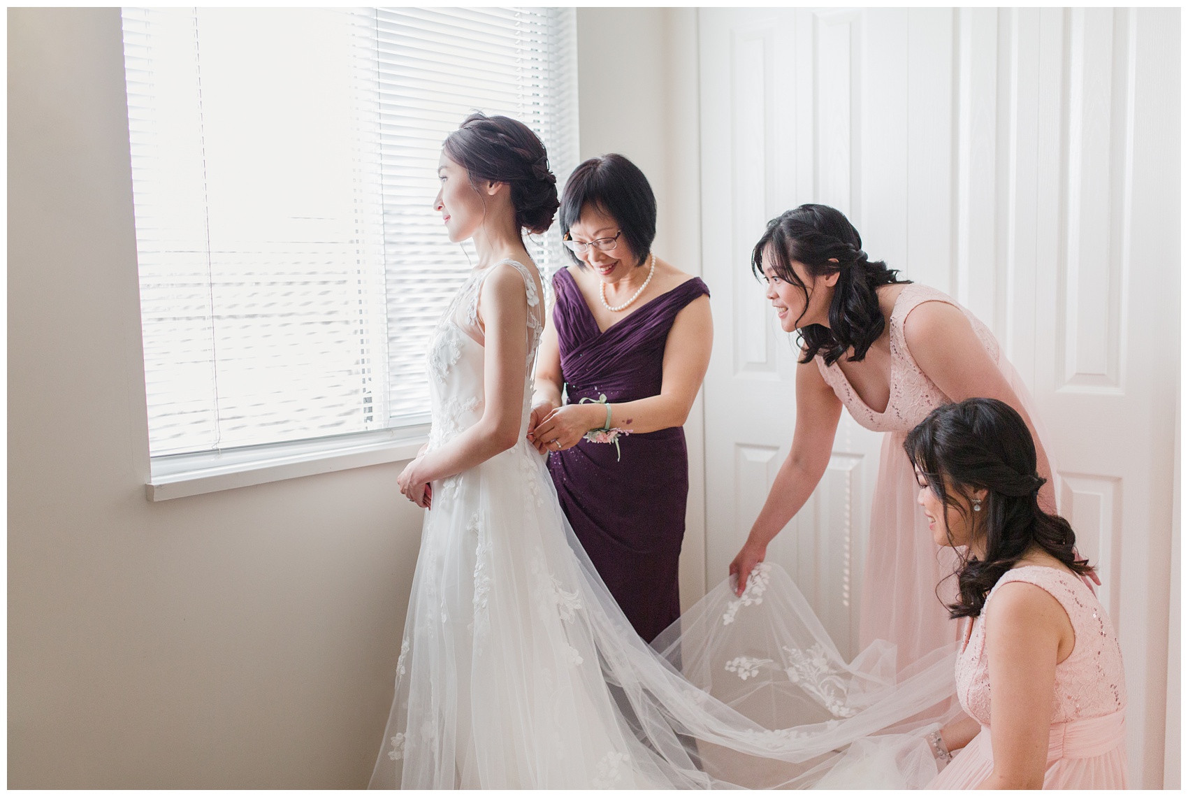 Bride getting ready for wedding day with mom and bridesmaids 