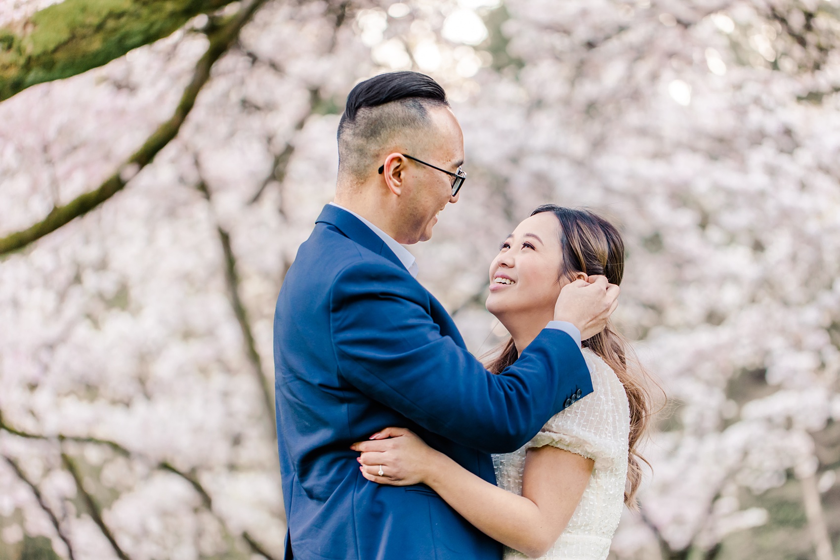 Stanley Park Cherry Blossoms engagement photo in Vancouver, BC, groom and bride looking at each other lovingly